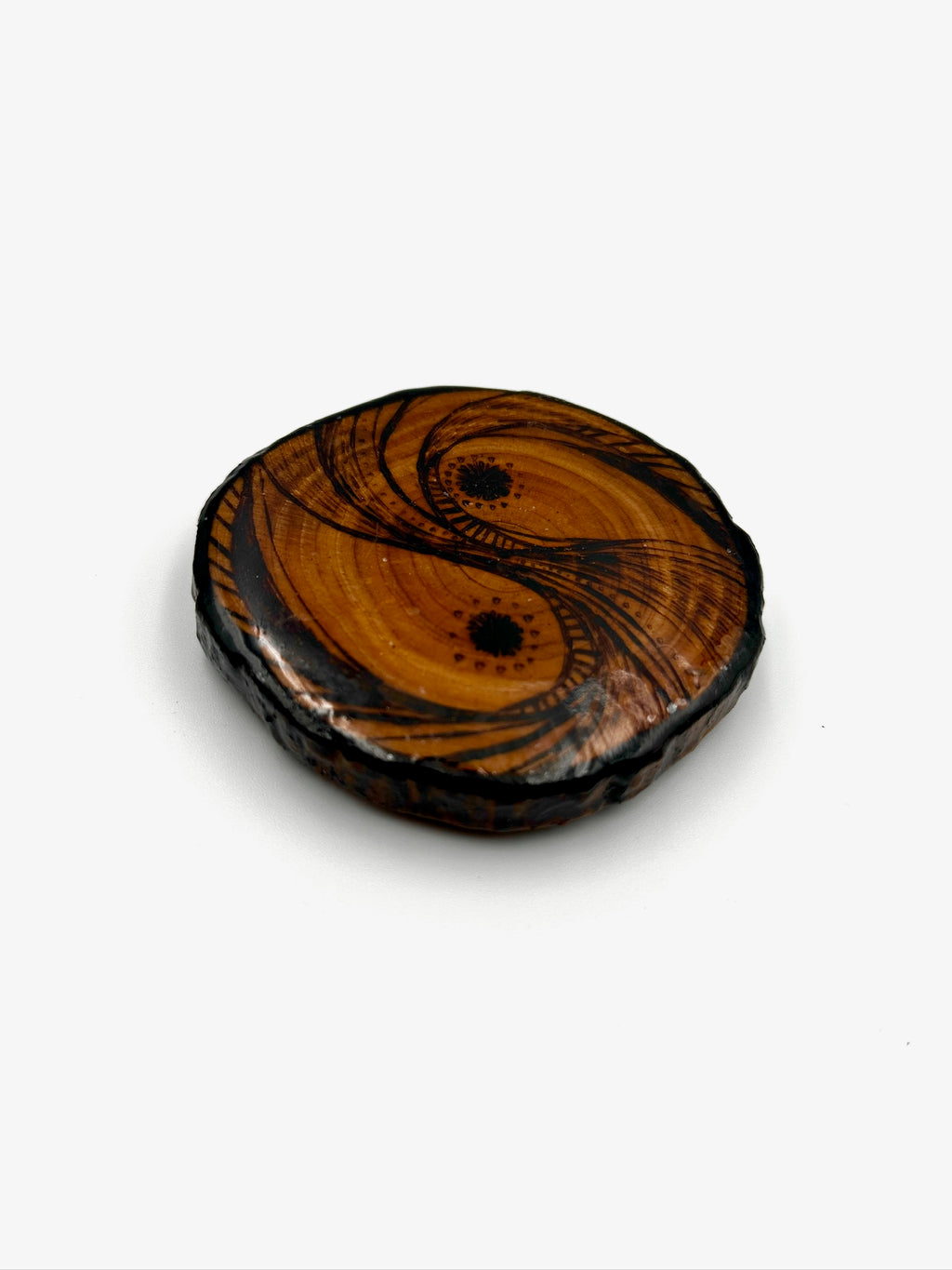 Wooden yin yang symbol on a white background