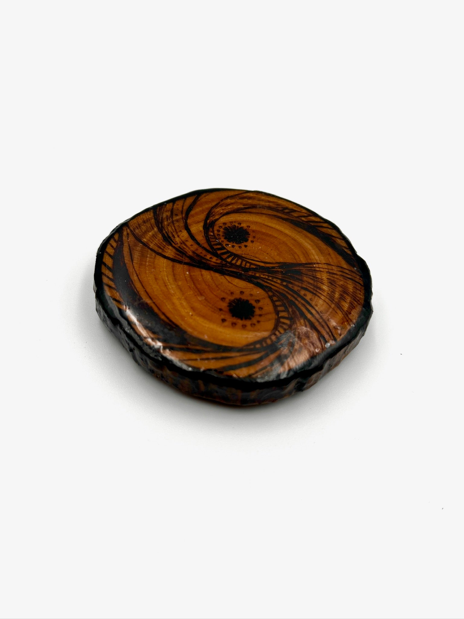 Wooden yin yang symbol on a white background