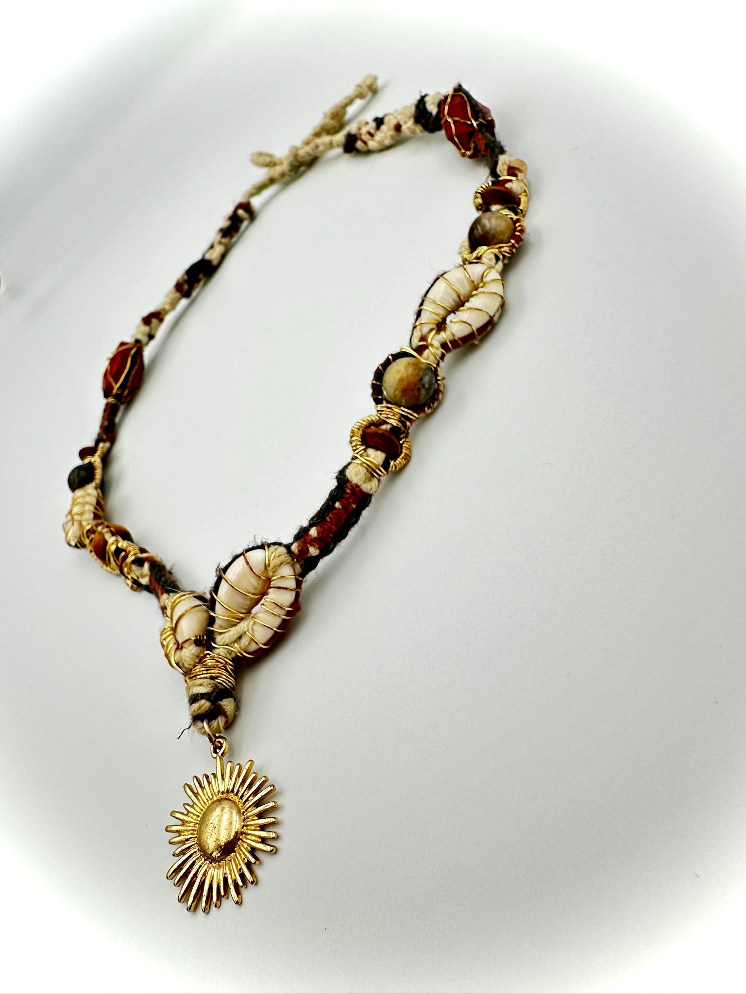 Necklace with shell and stone beads on a white background