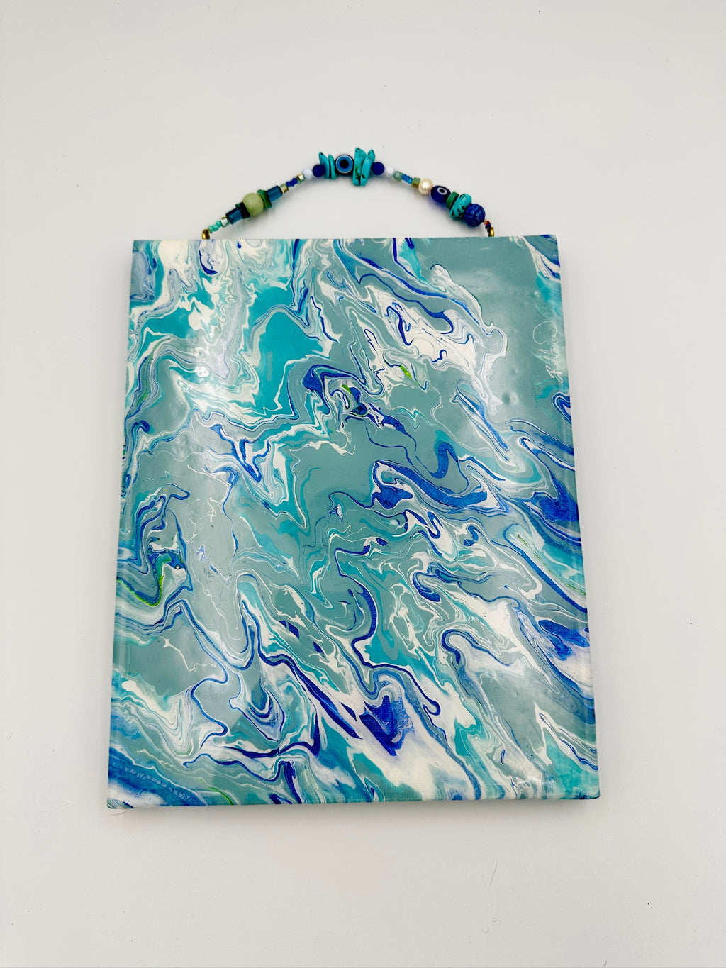 Marbled blue and green tote bag on a white background