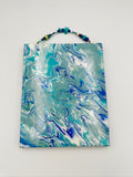 Marbled blue and green tote bag on a white background