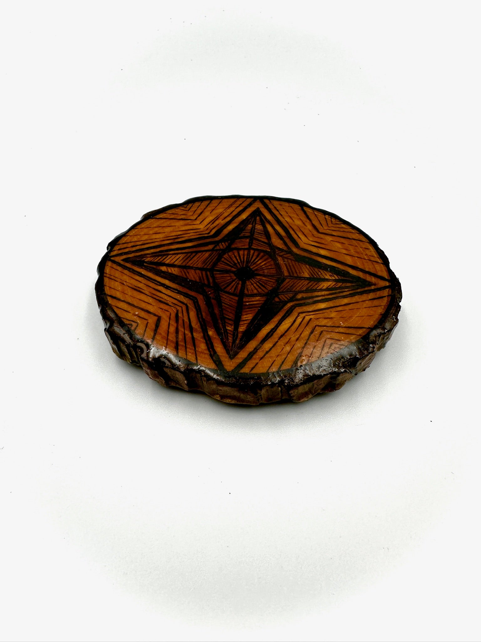 Wooden coaster with geometric design on a white background