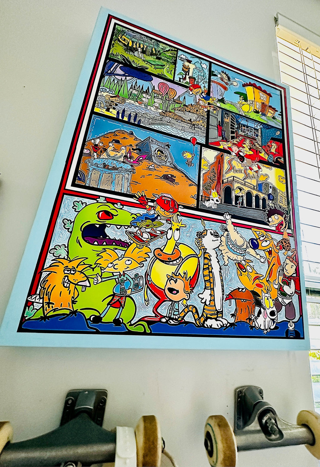 Colorful cartoon-style artwork on a wall with a skateboard in the foreground.