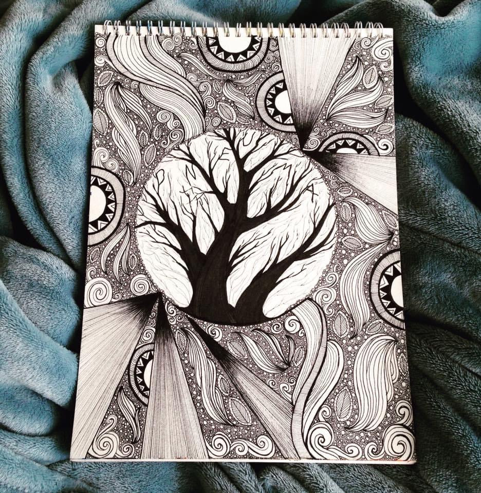 Notebook with a black and white tree design on a textured blue fabric background