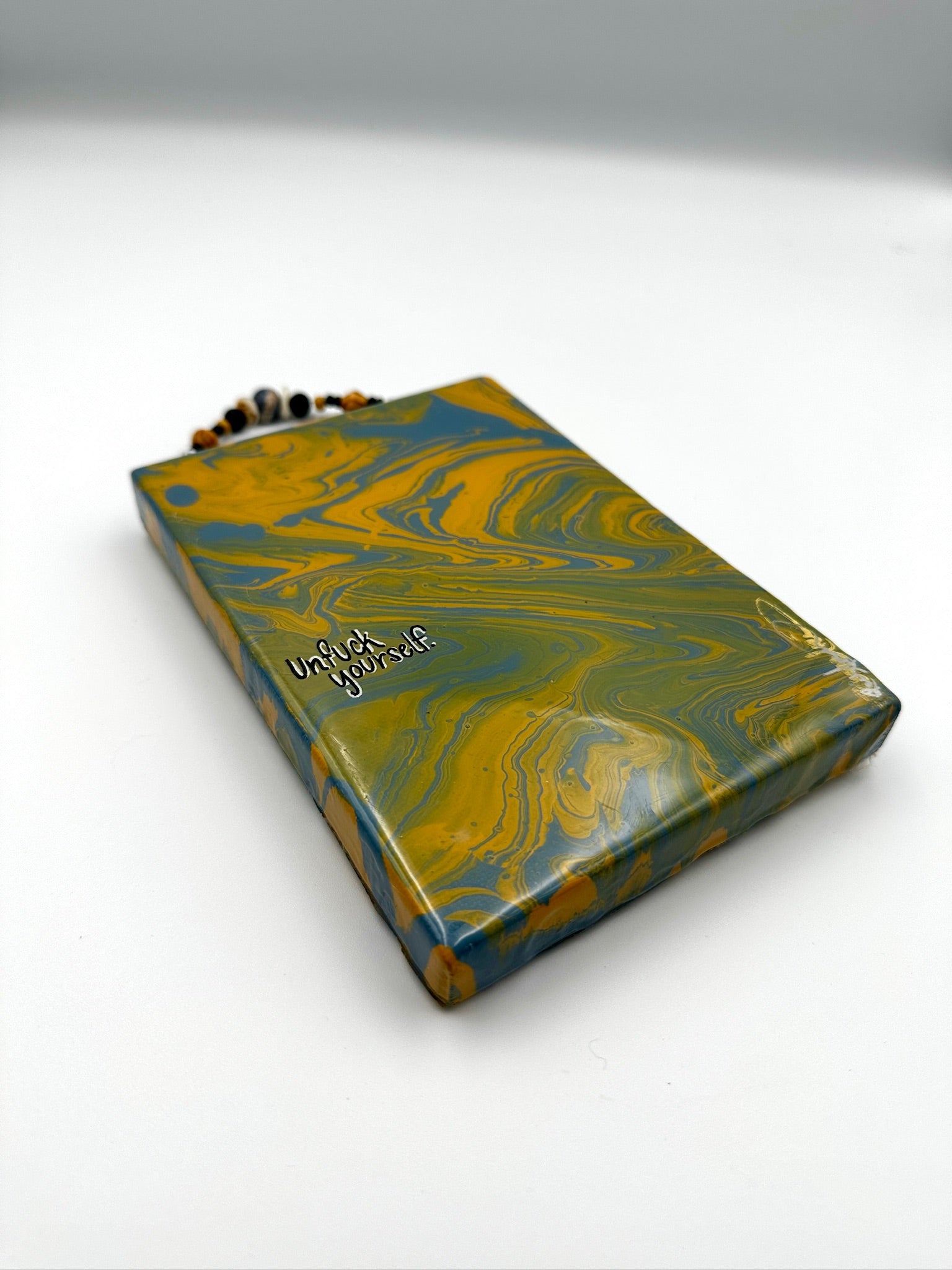 Marbled blue and yellow notebook on a white background