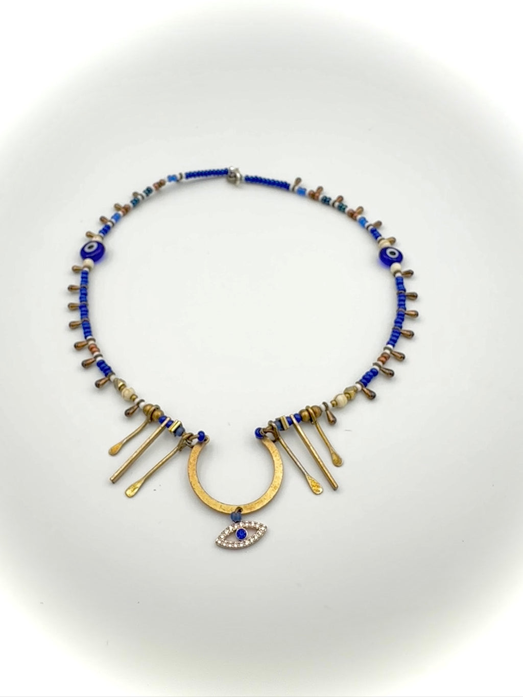Necklace with blue beads and gold accents on a white background
