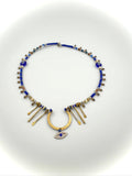 Necklace with blue beads and gold accents on a white background