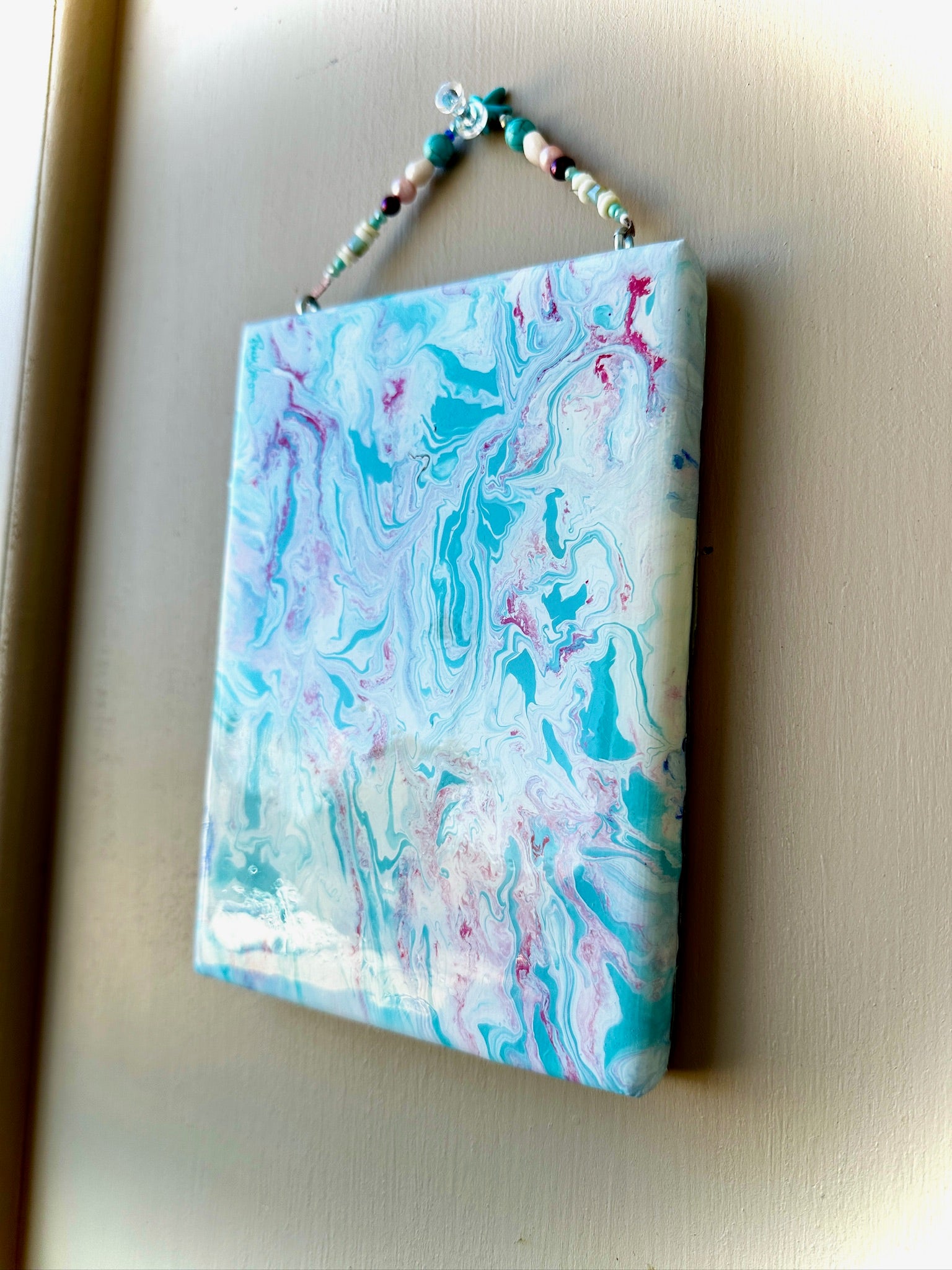 Marbled notebook with colorful design on a beige background