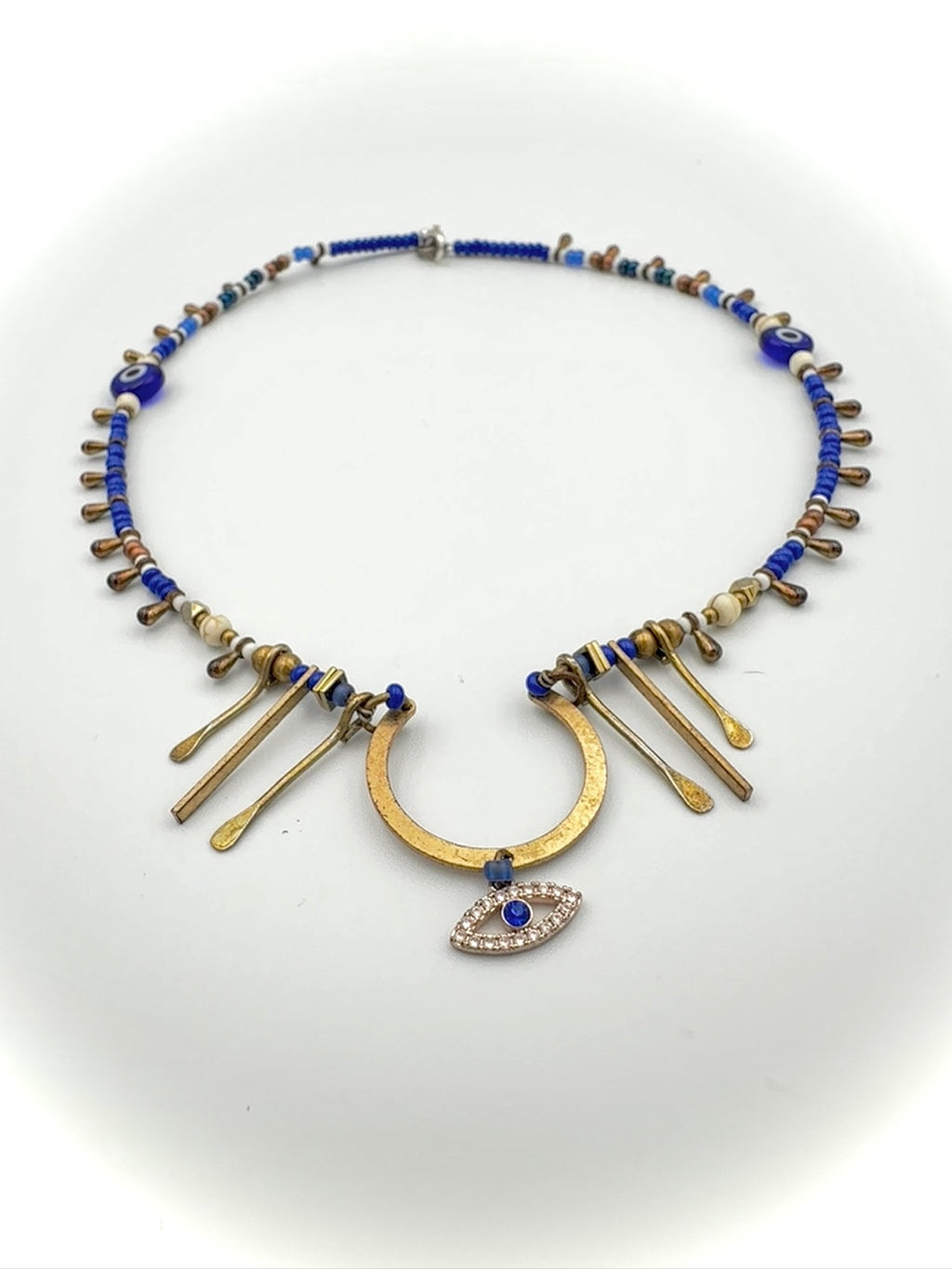 Necklace with blue beads and gold accents on a white background