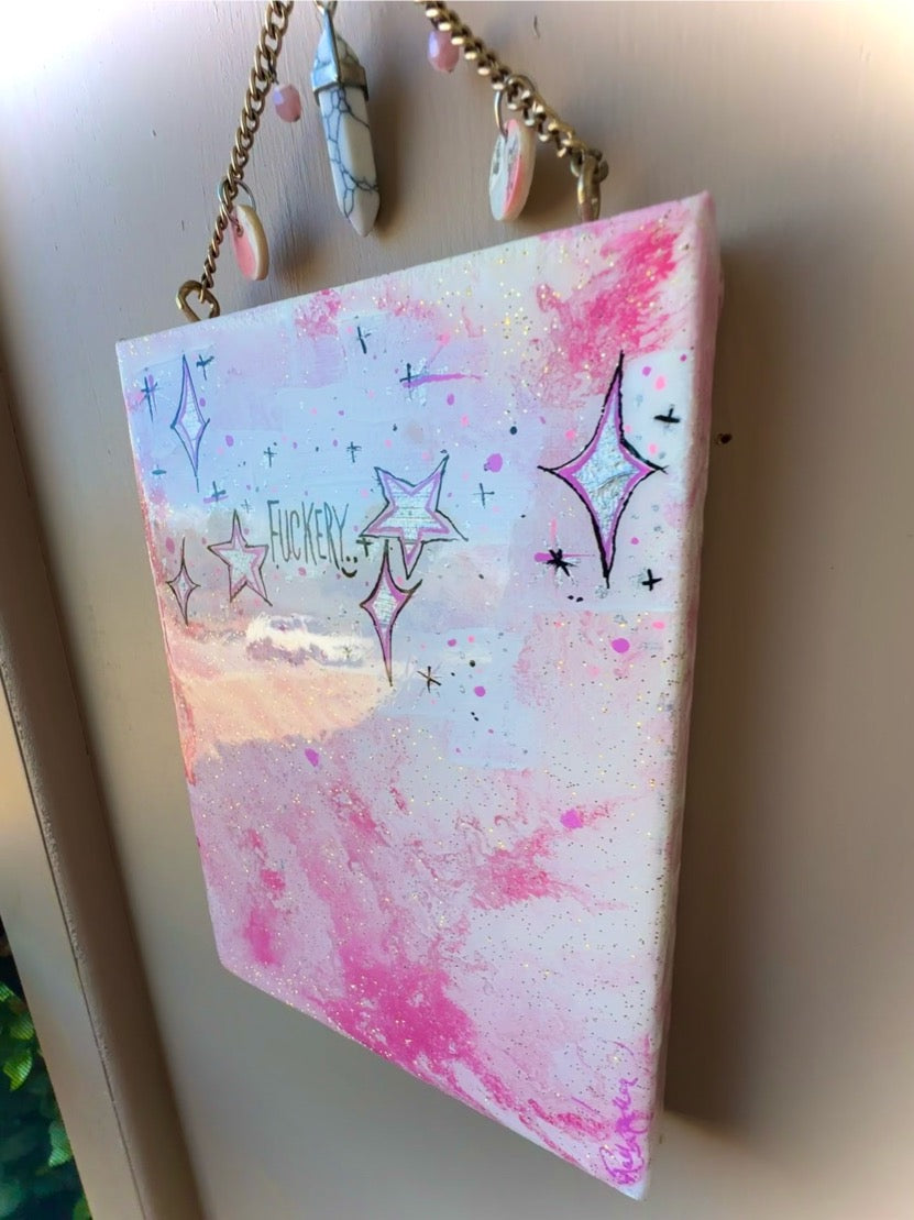 Pink and white watercolor notebook with star designs on a light background