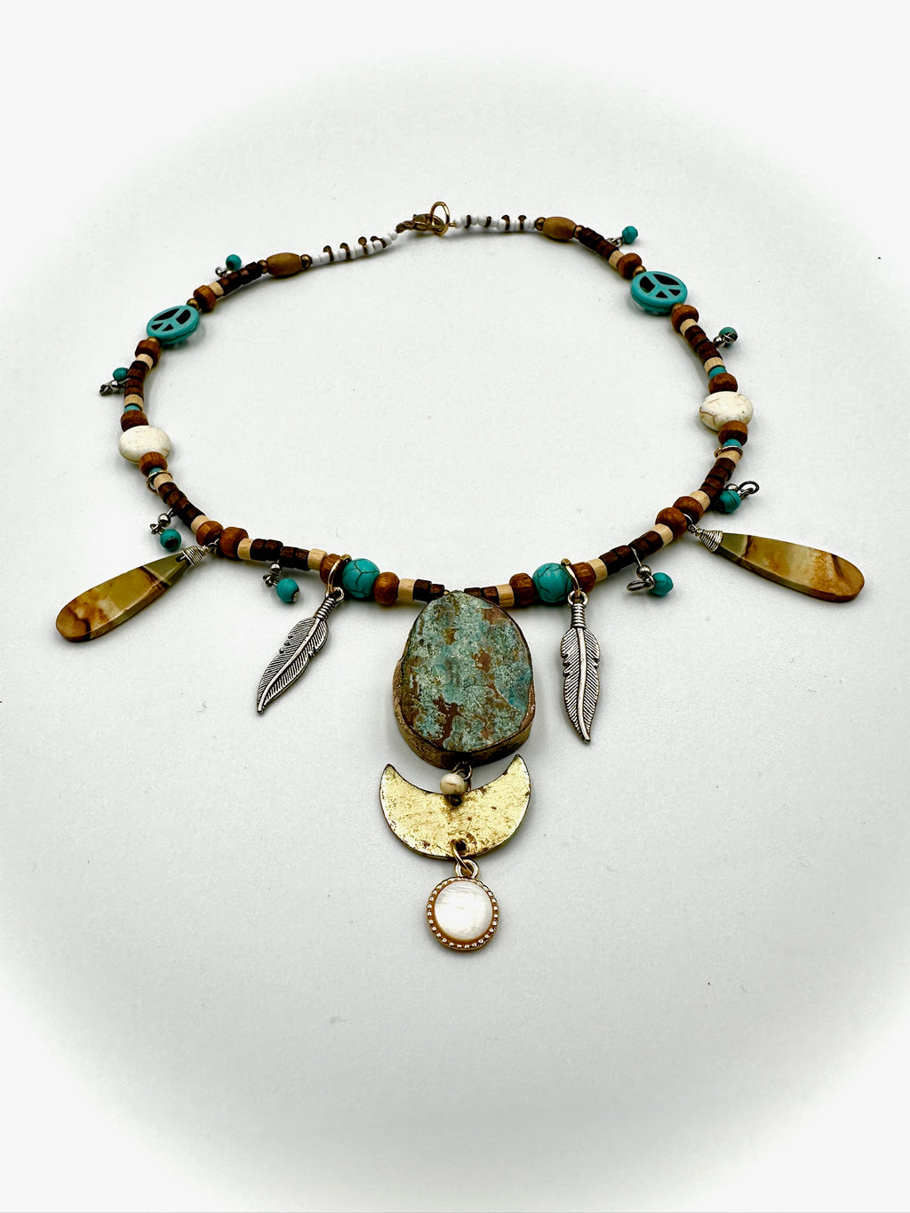 Necklace with beads and decorative elements on a white background