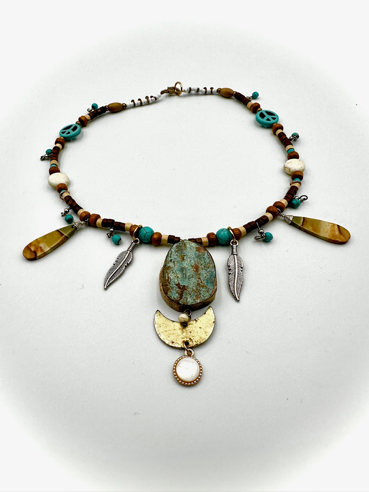 Necklace with beads and decorative elements on a white background