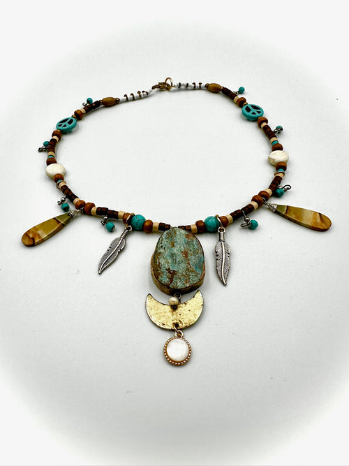 Necklace with beads and decorative elements on a white background