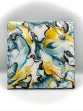 Abstract art piece with blue, yellow, and white colors on a white background