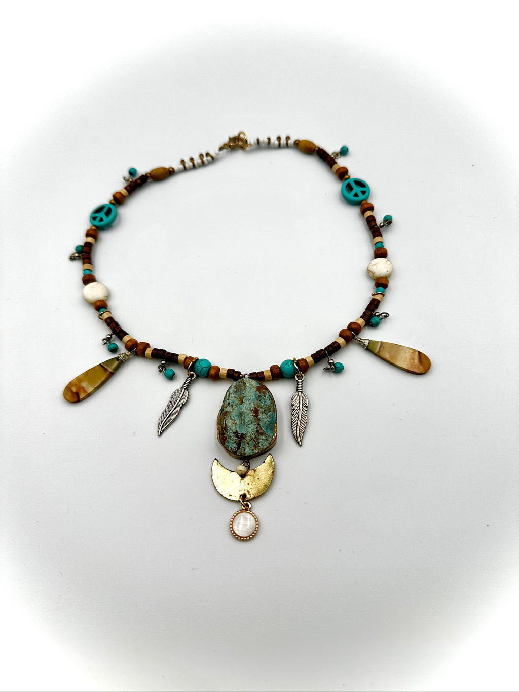 Necklace with beads and pendants on a white background