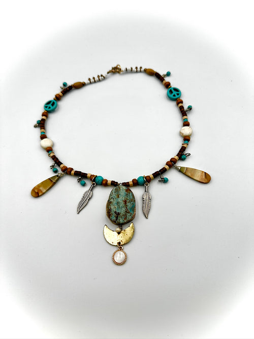 Necklace with beads and pendants on a white background