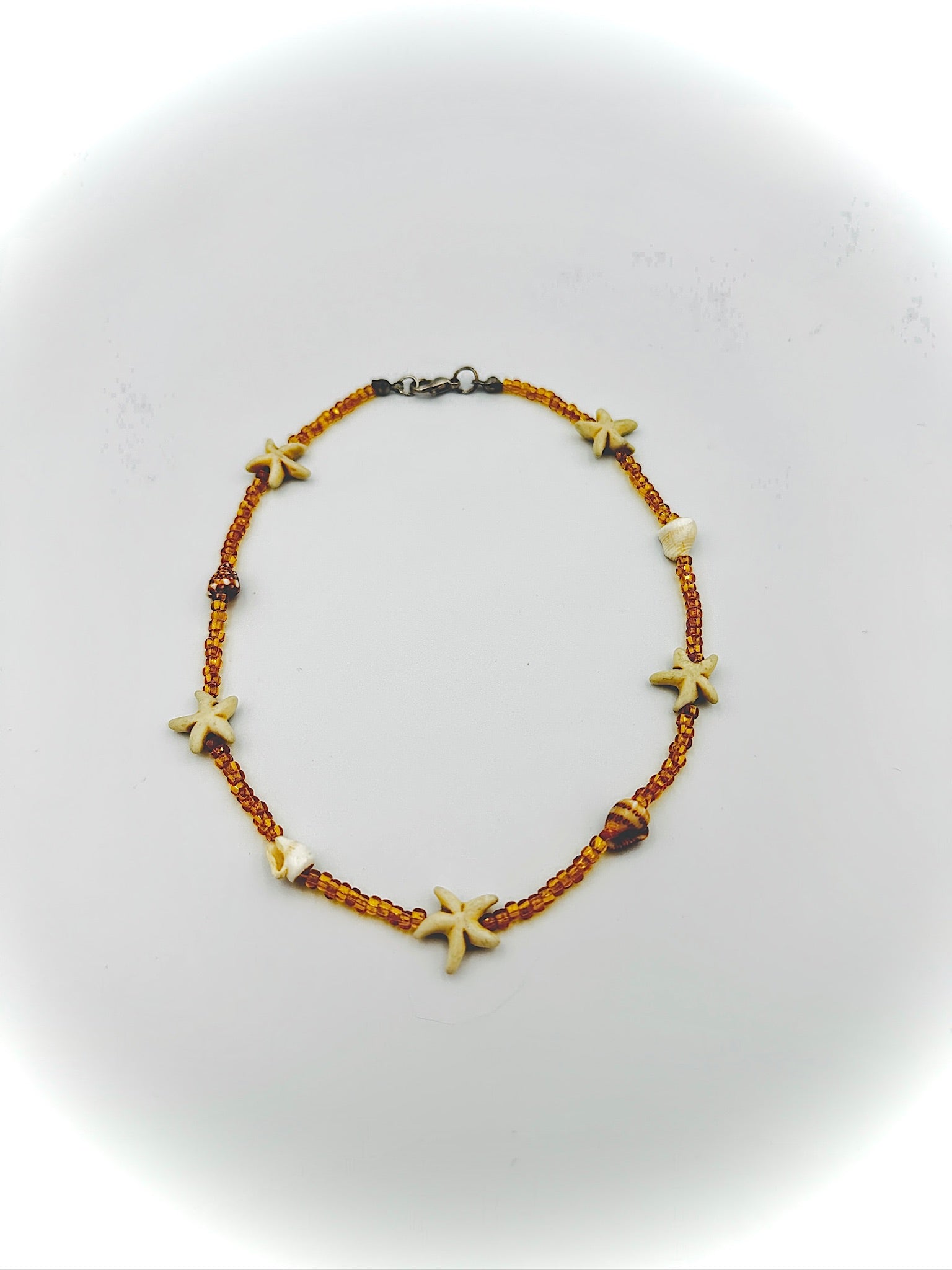 Necklace with starfish-shaped beads on a white background