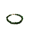 Green beaded bracelet on a white background