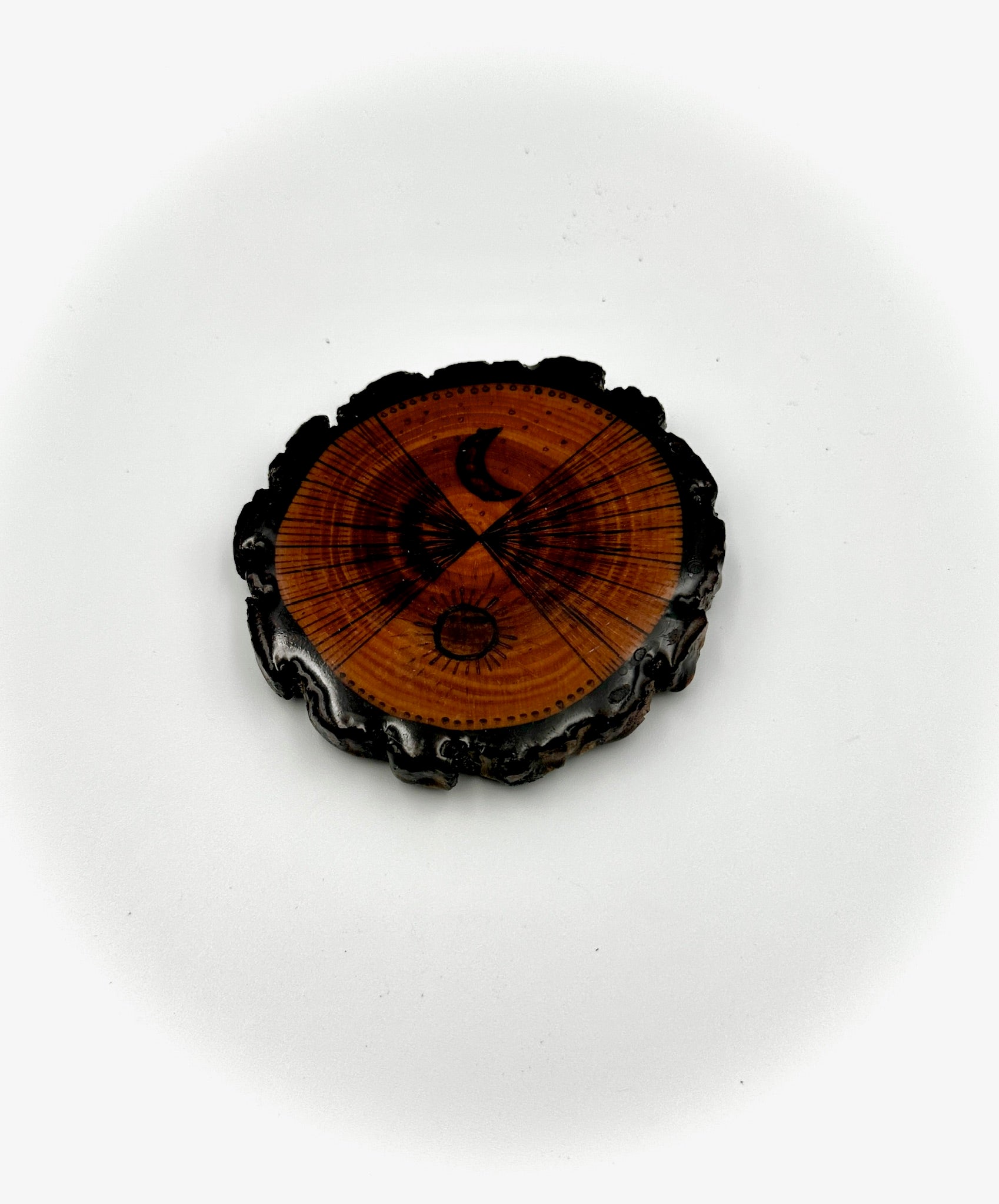 Decorative circular object with a wooden center and black frame on a white background