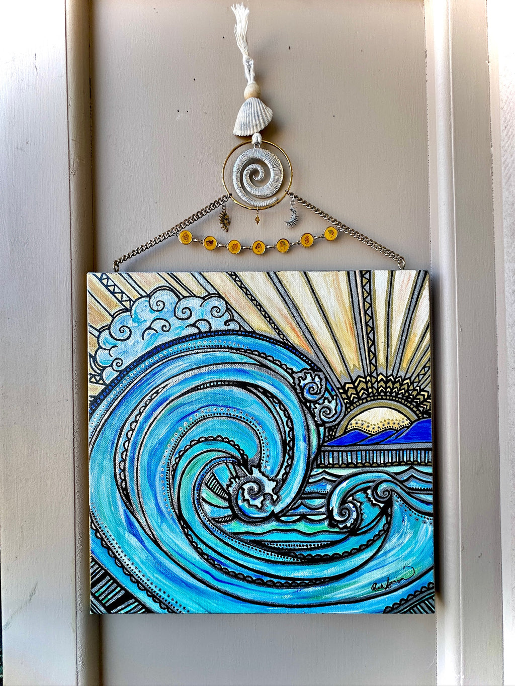 Decorative wall art with a blue wave design and shell elements on a white background