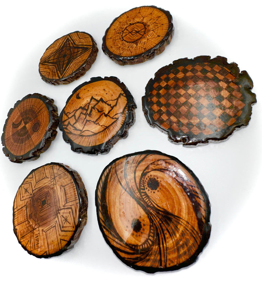 Set of wooden coasters with engraved patterns on a white background