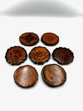 Set of wooden coasters with engraved patterns on a white background