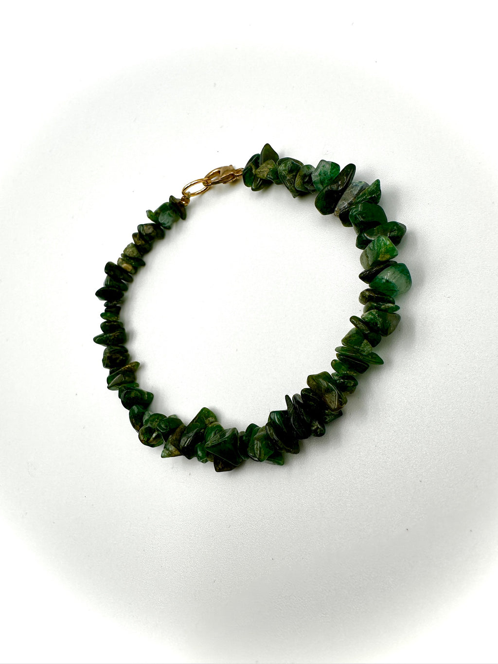 Green beaded bracelet on a white background