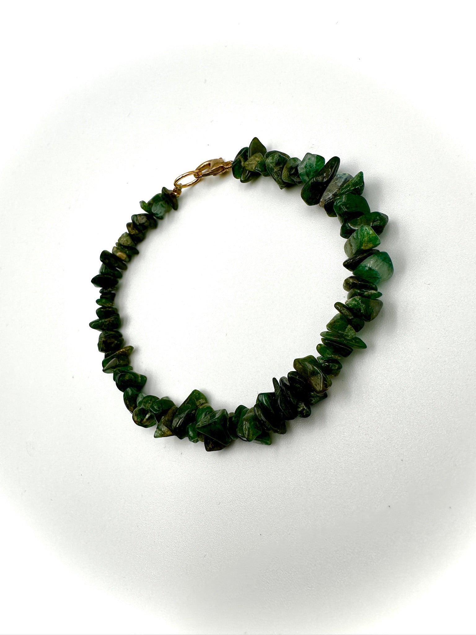 Green beaded bracelet on a white background