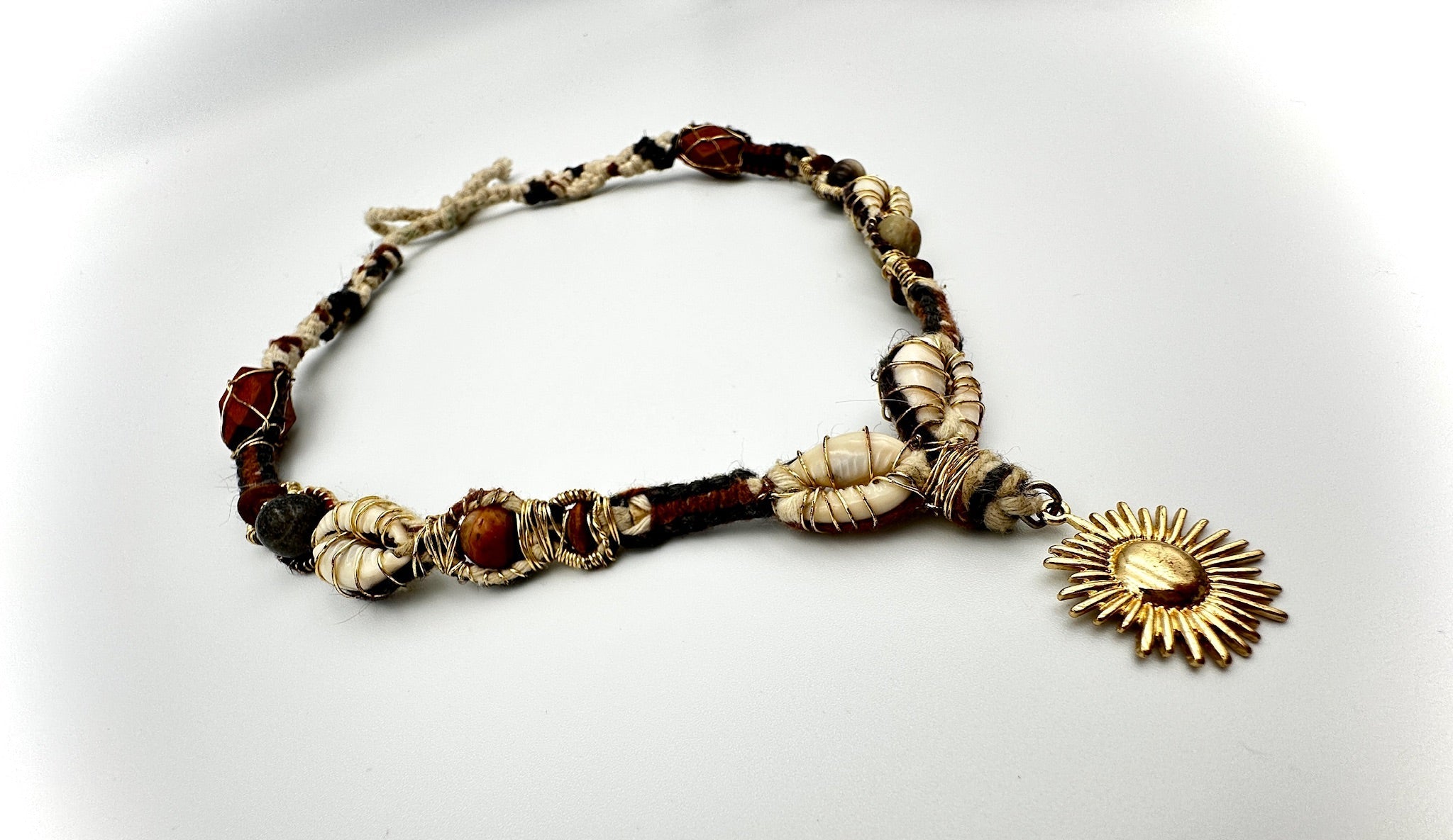 Bracelet with sun charm on a white background
