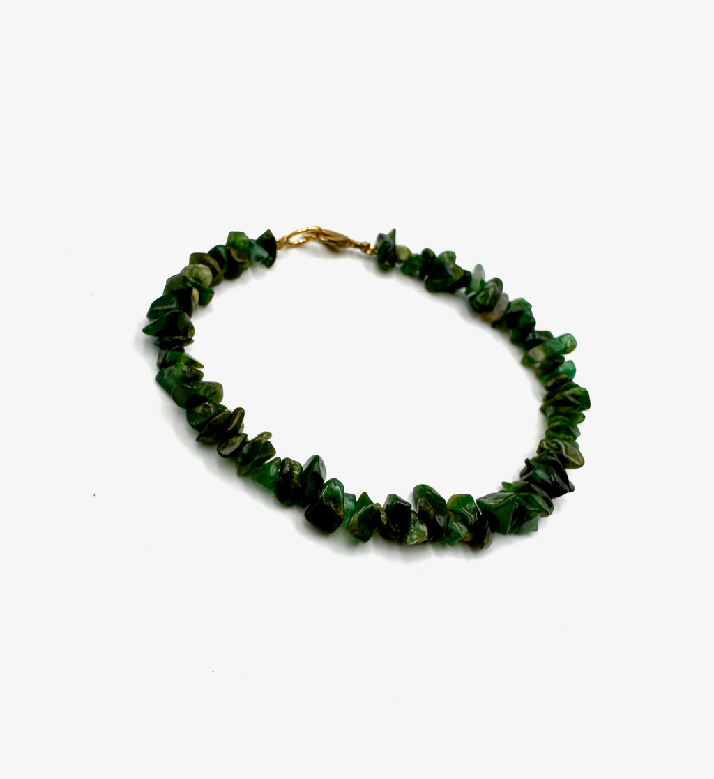 Green beaded bracelet on a white background