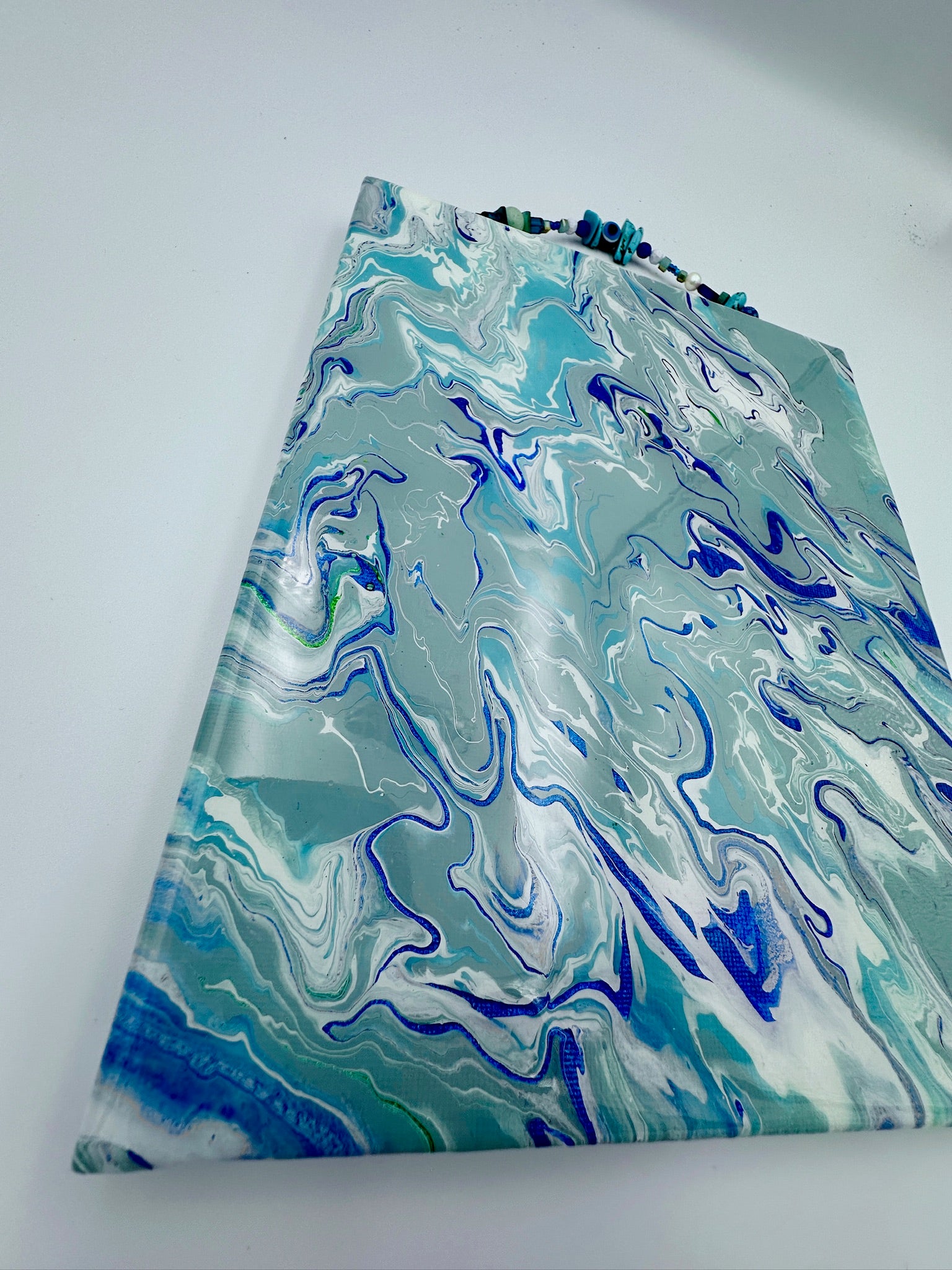 Marbled blue and green fabric on a white background