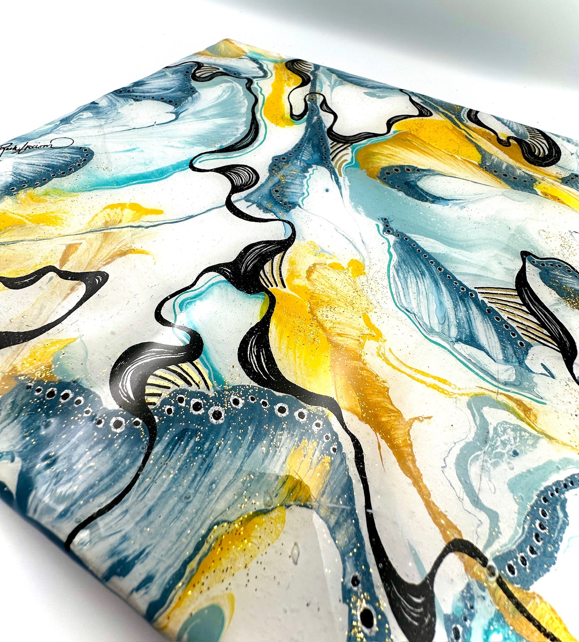 Abstract art piece with blue, yellow, and black colors on a white background