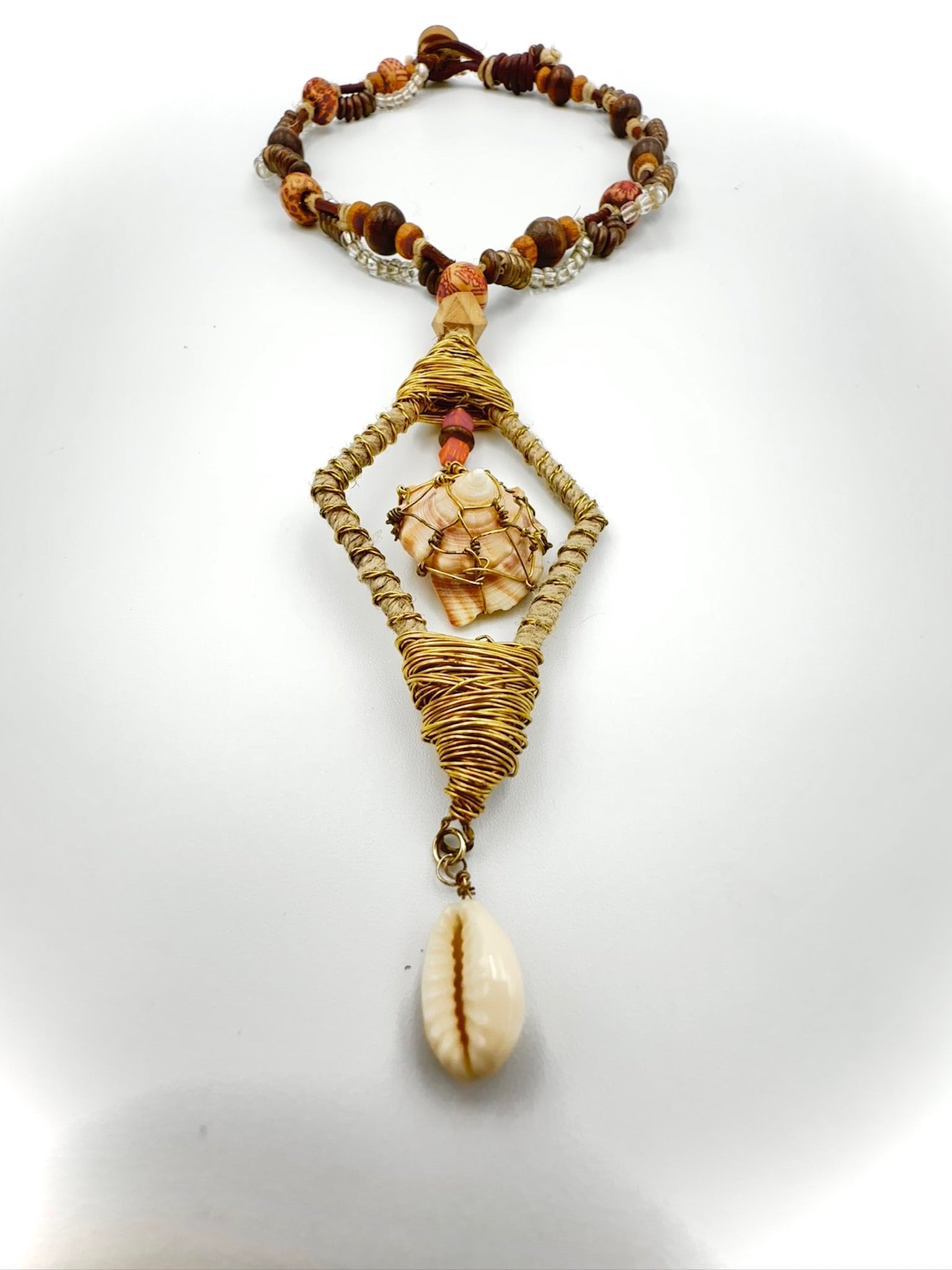 Necklace with shell pendant and beads on a white background