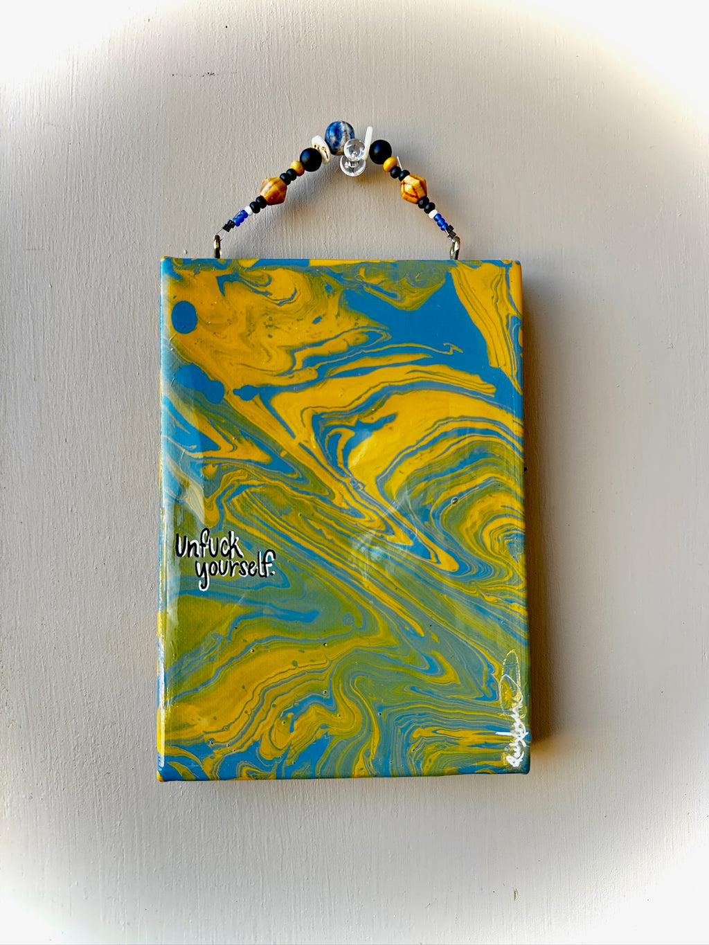 Marbled notebook with blue and yellow design on a white background