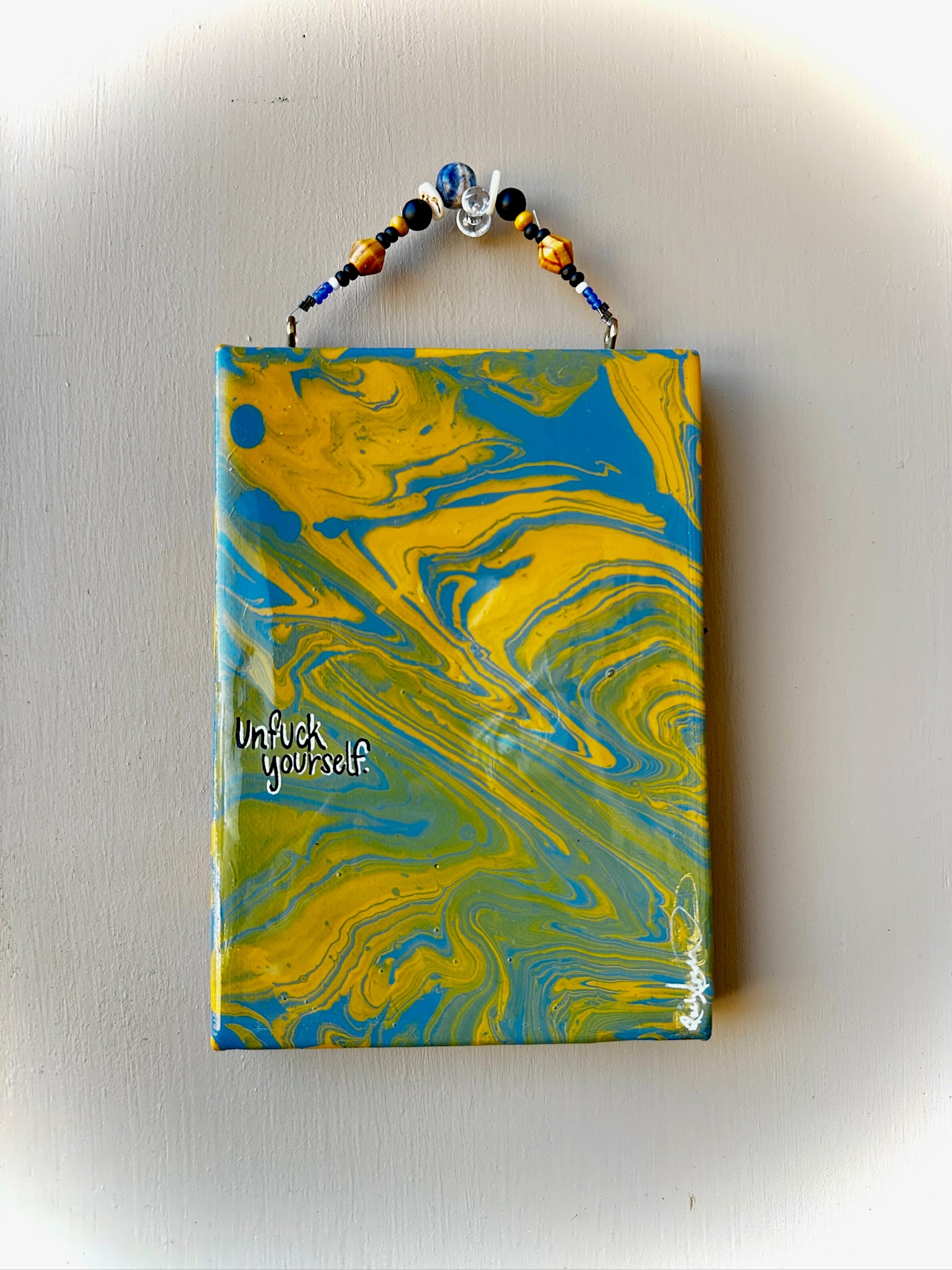 Marbled notebook with blue and yellow design on a white background